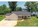 Waterfront home featuring a long driveway leading up to a 3 car garage, lush lawn, and inviting exterior at 4980 Kiser Island Rd, Terrell, NC 28682