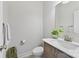 Neutral half bath with a wood vanity and light countertop, with decorative plants and artwork at 4980 Kiser Island Rd, Terrell, NC 28682