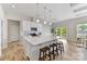 Open kitchen with large island, white cabinets, stainless appliances, and wood floors at 4980 Kiser Island Rd, Terrell, NC 28682