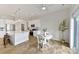 Bright kitchen and breakfast nook feature white cabinets, stainless appliances, and wood flooring at 4980 Kiser Island Rd, Terrell, NC 28682
