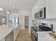 Bright kitchen features a farmhouse sink, stainless appliances, and an abundance of white cabinets at 4980 Kiser Island Rd, Terrell, NC 28682
