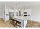 Bright kitchen with white cabinets, stainless appliances, and large center island with stool seating at 4980 Kiser Island Rd, Terrell, NC 28682