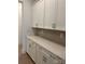 Elegant butler's pantry with white cabinets, quartz countertops, and stylish tiled backsplash at 5205 Mint Harbor Way # 0353, Charlotte, NC 28269