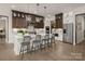Spacious kitchen featuring an island with barstool seating, stainless steel appliances, and elegant hardwood flooring at 5205 Mint Harbor Way # 0353, Charlotte, NC 28269