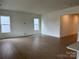 Spacious living room featuring luxury vinyl floors and natural light from large windows at 5205 Mint Harbor Way # 0353, Charlotte, NC 28269