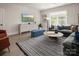 Cozy living room featuring a large sectional sofa, stylish decor, and plenty of natural light from the window at 5205 Mint Harbor Way # 0353, Charlotte, NC 28269