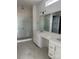 Luxurious bathroom featuring double vanity, quartz countertops, and glass-enclosed shower at 5205 Mint Harbor Way # 0353, Charlotte, NC 28269
