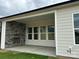 Covered patio with a stone fireplace, perfect for outdoor entertaining and relaxation at 5205 Mint Harbor Way # 0353, Charlotte, NC 28269