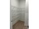 Walk-in pantry with wood floors and ventilated metal shelving providing optimal storage space at 5205 Mint Harbor Way # 0353, Charlotte, NC 28269