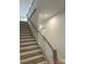 A bright staircase with white railings and wooden treads leads to the upper level at 5205 Mint Harbor Way # 0353, Charlotte, NC 28269