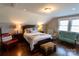 Charming bedroom showcasing hardwood floors, a sitting area with settee, and a queen-sized bed at 601 Meadowbrook Rd, Kings Mountain, NC 28086