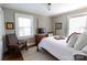 Cozy bedroom featuring a four-poster bed, area rug, and natural light from two windows at 601 Meadowbrook Rd, Kings Mountain, NC 28086