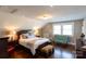 Charming bedroom showcasing hardwood floors, a sitting area with settee, and a queen-sized bed at 601 Meadowbrook Rd, Kings Mountain, NC 28086