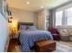 Bright bedroom features blue checkered bedding, a red reading chair, and lots of natural light at 601 Meadowbrook Rd, Kings Mountain, NC 28086