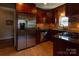 Well-equipped kitchen with stainless steel appliances, dark granite countertops, and rich wooden cabinets at 601 Meadowbrook Rd, Kings Mountain, NC 28086