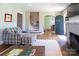 Inviting living room with hardwood floors, archway details, neutral walls, and a comfortable plaid chair and ottoman at 601 Meadowbrook Rd, Kings Mountain, NC 28086
