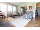 Bright living room featuring hardwood floors, large windows, a fireplace, and comfortable seating at 601 Meadowbrook Rd, Kings Mountain, NC 28086
