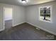 Bedroom showcasing neutral walls, gray carpet, and a bright window view to the outdoors at 614 Normandy Rd, Lancaster, SC 29720