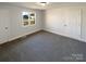Cozy bedroom with neutral walls, plush carpet, and a bright window to the outside at 614 Normandy Rd, Lancaster, SC 29720