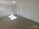 Spacious bonus room offering neutral walls, plush carpet, and multiple doors for convenient access at 614 Normandy Rd, Lancaster, SC 29720