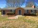 Charming brick home featuring a well-manicured lawn and quaint front porch, with blue shutters at 614 Normandy Rd, Lancaster, SC 29720