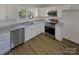 Modern kitchen featuring stainless steel appliances, white cabinets, and a sleek countertop at 614 Normandy Rd, Lancaster, SC 29720