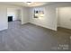 Bright living room with neutral walls, gray carpet, a fireplace, and a large window offering ample natural light at 614 Normandy Rd, Lancaster, SC 29720