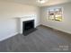 Bright living room featuring a decorative fireplace and a large window for ample natural light at 614 Normandy Rd, Lancaster, SC 29720