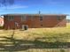Rear view of the home, showcasing its brick exterior and spacious backyard at 614 Normandy Rd, Lancaster, SC 29720
