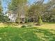 A large backyard with luscious green grass and mature trees at 6325 Hawkwood Ln, Charlotte, NC 28277