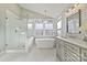 Bathroom with dual sink vanity, soaking tub and glass shower at 6325 Hawkwood Ln, Charlotte, NC 28277
