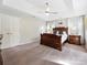 Spacious bedroom with ceiling fan, carpet, natural light, and classic wood furniture at 6325 Hawkwood Ln, Charlotte, NC 28277