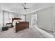 Bedroom featuring plush carpet, ceiling fan, king bed and ensuite bath at 6325 Hawkwood Ln, Charlotte, NC 28277