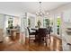 Bright eat-in kitchen area with hardwood floors, a chandelier, and access to the living room at 6325 Hawkwood Ln, Charlotte, NC 28277