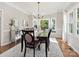Formal dining room with a dark wood table, seating for six, a chandelier, and large bay windows at 6325 Hawkwood Ln, Charlotte, NC 28277