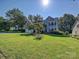 A beautiful two-story home featuring a sprawling green lawn at 6325 Hawkwood Ln, Charlotte, NC 28277