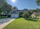 Home exterior featuring a driveway, lush lawn and two car garage at 6325 Hawkwood Ln, Charlotte, NC 28277
