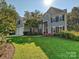 Inviting traditional two-story home with a well-manicured lawn, beautiful landscaping, and a two-car garage at 6325 Hawkwood Ln, Charlotte, NC 28277