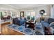 Cozy living room with hardwood floors, a patterned rug, comfortable seating, and lots of natural light at 6325 Hawkwood Ln, Charlotte, NC 28277