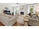 Inviting living room with a fireplace, hardwood floors, and ample natural light at 6325 Hawkwood Ln, Charlotte, NC 28277