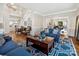 Bright living room featuring hardwood floors, staircase, elegant furniture, and an open floor plan at 6325 Hawkwood Ln, Charlotte, NC 28277