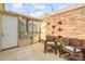 Cozy backyard patio area with seating, string lights, and a brick accent wall for outdoor enjoyment at 6354 Old Pineville Rd # F, Charlotte, NC 28217