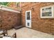 This brick patio features a door for entry, plus a pet door and bed for your furry friend at 6354 Old Pineville Rd # F, Charlotte, NC 28217