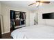 This bedroom with a walk-in closet, wood-look floors, and ceiling fan is a comfortable and organized retreat at 6354 Old Pineville Rd # F, Charlotte, NC 28217
