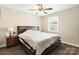 Bedroom features wood-look floors, neutral walls, ceiling fan, and natural light from a window at 6354 Old Pineville Rd # F, Charlotte, NC 28217