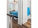 Bedroom with blue bedding leads to a bathroom, offering a convenient en-suite layout at 6354 Old Pineville Rd # F, Charlotte, NC 28217