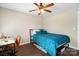 Comfortable bedroom features a ceiling fan, dark wood floors, and an adjacent desk at 6354 Old Pineville Rd # F, Charlotte, NC 28217