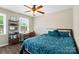 This bedroom, with a desk, bookshelf, and blue bedding, is the perfect space for work and relaxation at 6354 Old Pineville Rd # F, Charlotte, NC 28217
