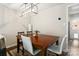 Dining room featuring a wood table, modern lighting, and stylish seating for four at 6354 Old Pineville Rd # F, Charlotte, NC 28217