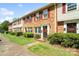 Charming townhomes featuring brick and vinyl siding, red shutters, and well-manicured lawns at 6354 Old Pineville Rd # F, Charlotte, NC 28217